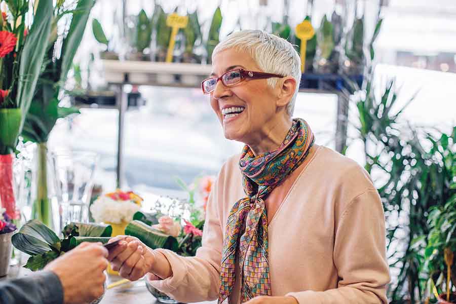Woman wearing hearing aids buying flowers
