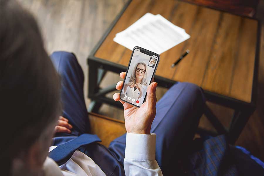Man having a telehealth hearing evaluation appointment
