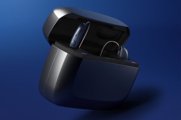 A pair of Beltone Envision hearing aids charging in their battery case